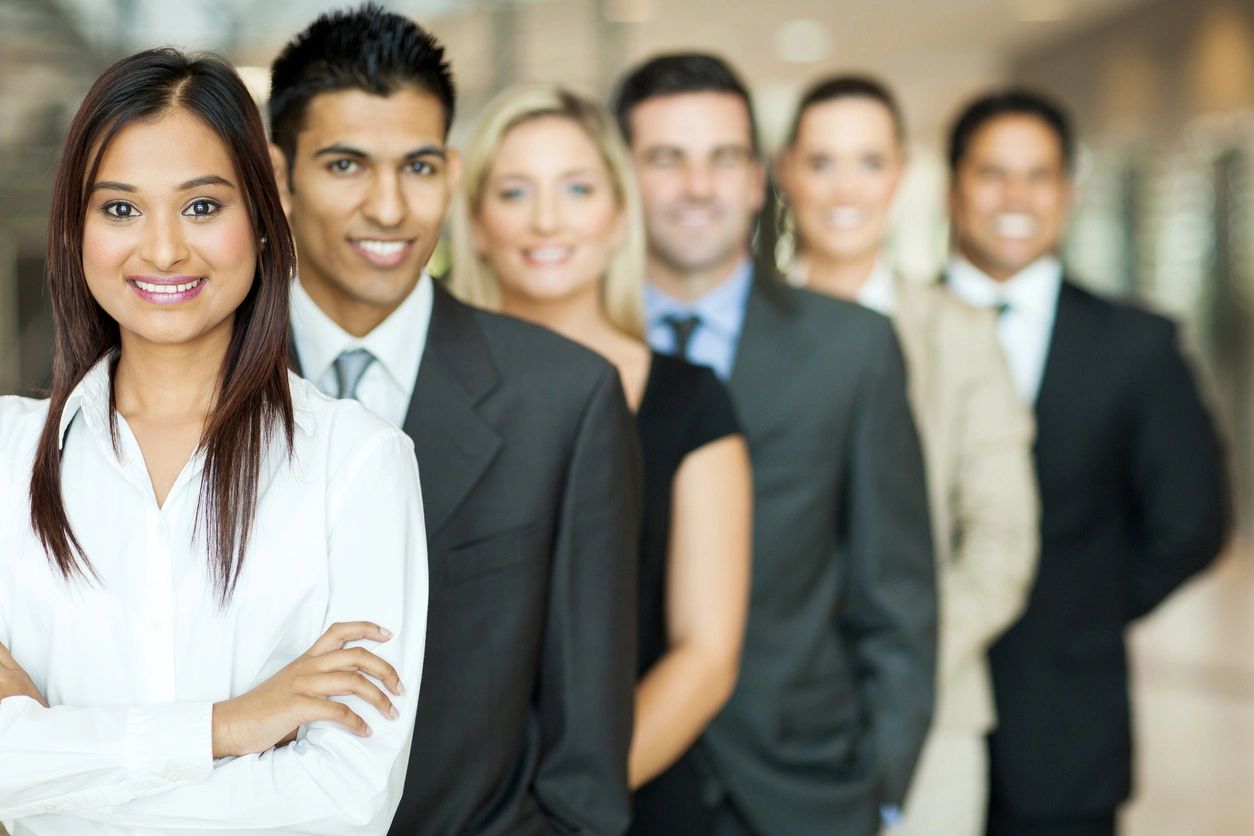 A group of people in suits and ties standing next to each other.